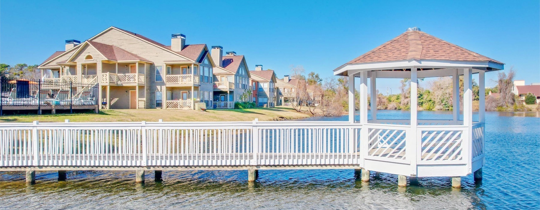 a dock with a gazebo on it by a body of water