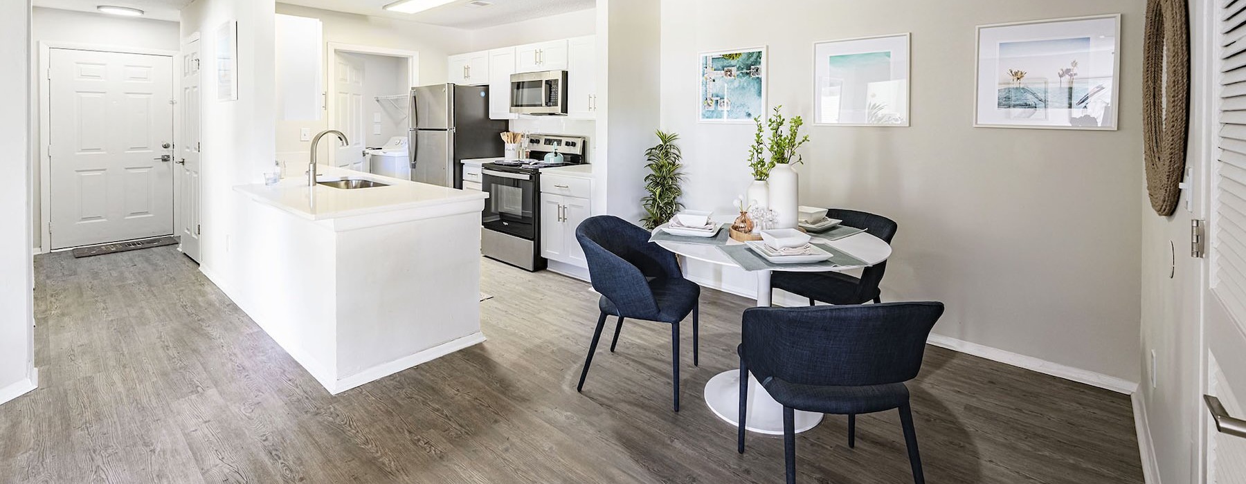 a kitchen with a dining table and chairs